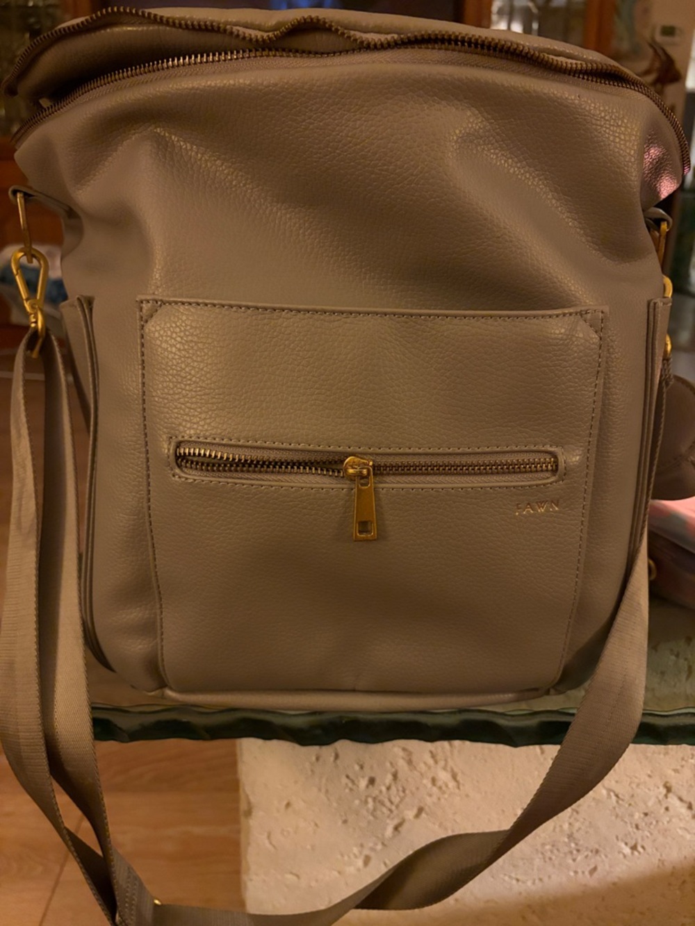 Fawn Design Leather Diaper Bag with adj  straps, pacifier holder, changing pad.